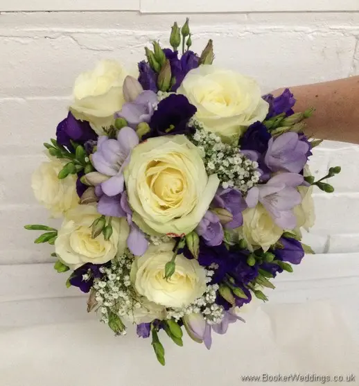 Purple and cream wedding flower Bridal Bouquet with ivory avalanche roses, purple lissianthus, lilac freesia and gypsy grass