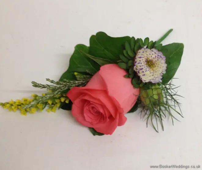 Bright and wild Coral rose, solidaster and nigella grooms buttonhole