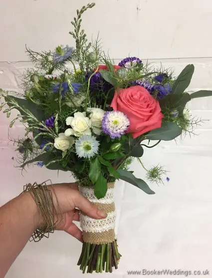 Bright and wild coral, pink and blue bridesmaid bouquet side view