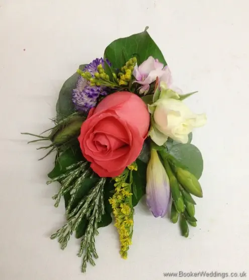 Bright and wild just picked pin corsage with Nigella, Coral Roses, White spray roses, Solidaster, Purple Freesia, Pink Phlox