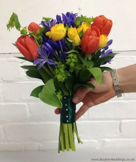 Brightly Coloured Bridesmaid Bouquet in Primary Colours with Tulips, Agapanthus and Spray Roses Side View