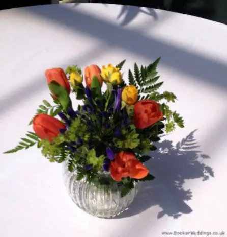 Brightly Coloured Jars of Flowers Reception Table Centrepieces in Primary Colours with Tulips, Agapanthus and Spray Roses at The Palm House, Sefton