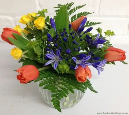 Brightly Coloured Jars of Flowers in Primary Colours with Tulips, Agapanthus and Spray Roses
