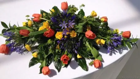 Brightly Coloured Low and Long Top Table Arranagement in Primary Colours with Tulips, Agapanthus and Spray Roses at The Palm House, Sefton