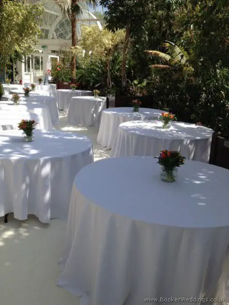 Jars of brightly Coloured Flowers Reception Table Centrepieces at The Palm House, Sefton