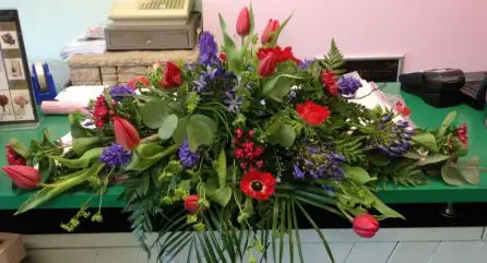 Red and Blue Tulip Agapantha Bouvardia and Hyacinth and Anenome  Top Table Arrangement Back  - Meaning of Flowers