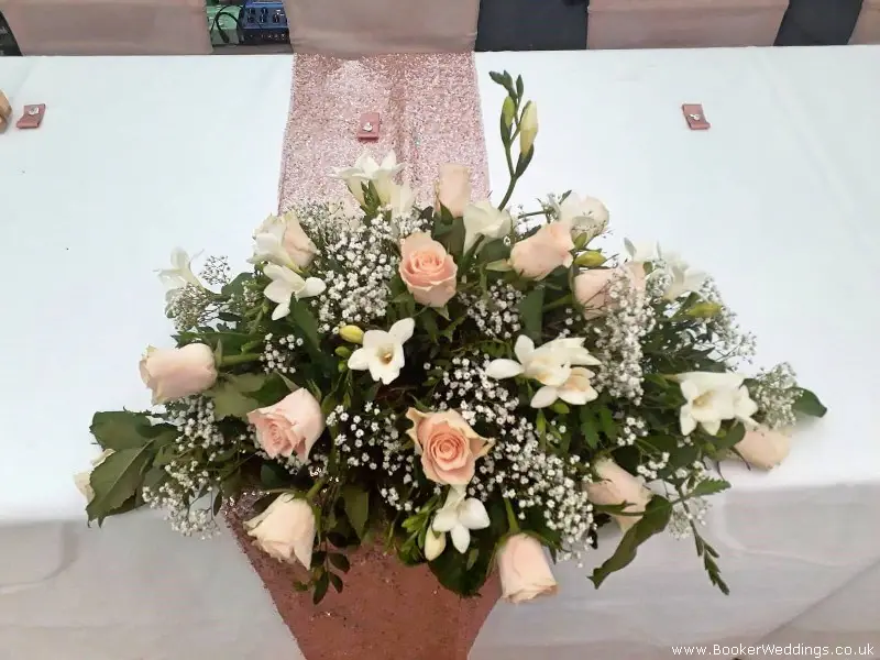 Tob Table Centrepiece of Roses Freesia and Gypsophila For Rose Gold Wedding