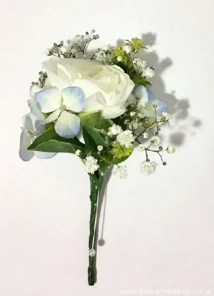 Groom buttonhole of white ranunculus, hydrangea and gypsy grass