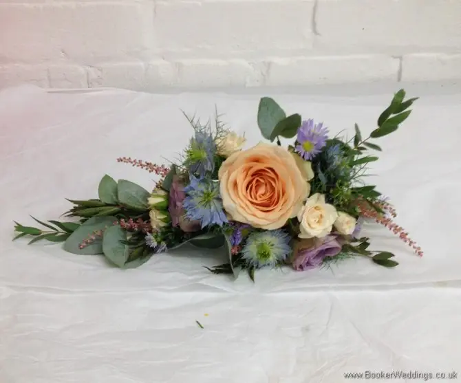 Wild garden flowers themed wedding flowers pin corsage with roses, spray roses, astilbe, lissianthus and nigella side view
