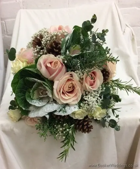 Winter wonderland bridal bouquet of blush roses ivory brassica, glitterd gypsy grass, conifer and pinecones_top