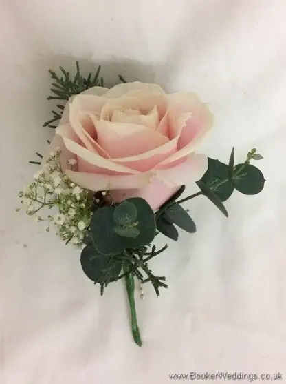 Winter wonderland wedding grooms buttonhole of blush rose, gypsy grass and greenery