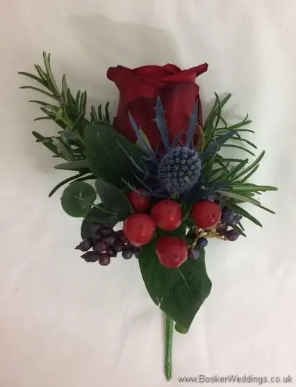 Christmas wedding Grooms buttonhole with red rose, eryngium and foliage
