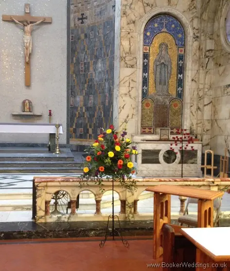 Bright and vibrant large pedestal arrangement at St Phillips Neri Church