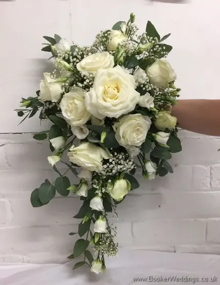 All white shower bouquet with eucalyptus foliage featuring roses, gypsy grass and lissianthus front