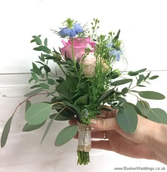 Rustic flowergirl bouquet with roses, aster daisy, nigella, spray roses, Astilbe, Lissianthus and eucalyptus side view