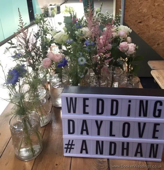 Wild just picked rustic flowers in bottle table centrepieces