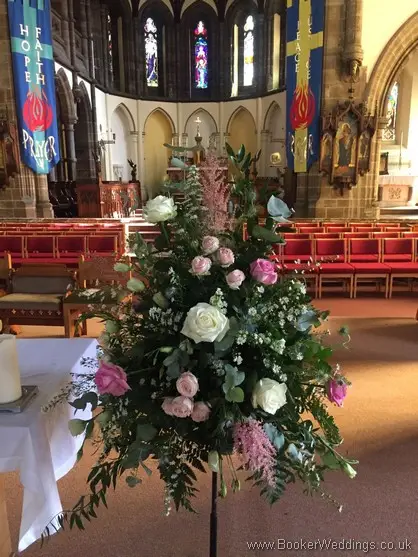 Wild just picked rustic pink, cream and blue pedestal arrangement at St Annes Church, Liverpool