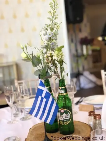 Table Centrepieces of Flowers in Beer Bottles