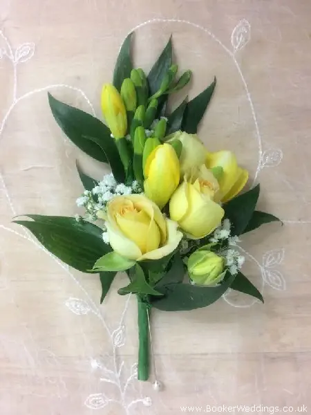 Corsage for wedding party with freesia, spray roses and gypsy grass
