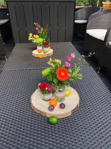 Bright Flowers In Decorated Jam Jar Table Centrepiece