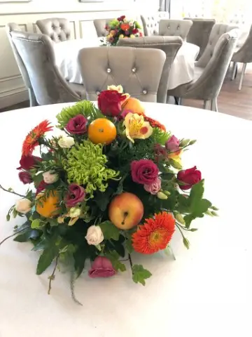 Bright and Vibrant Table Centrepiece With Blooms Gerbera Apples Limes