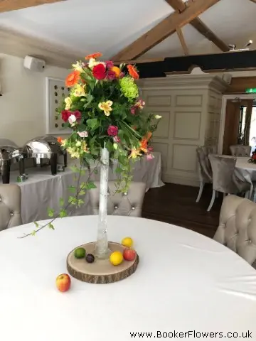 Tall Table Centrepiece With Bright And Vibrant Fruit And Flowers