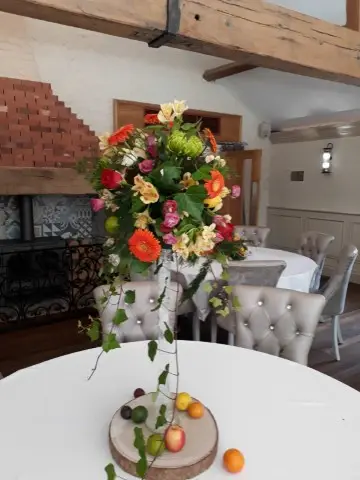 Tall Table Centrepiece With Bright Fruit And Flowers