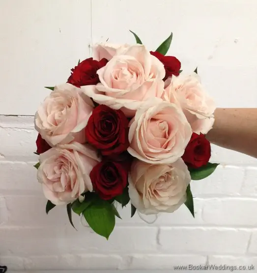 Bridal hand-tied bouquet featuring red and soft pink roses