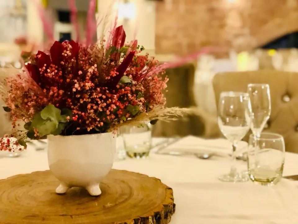 Red and Pink Dried Floral Table Decoration on Log Slice