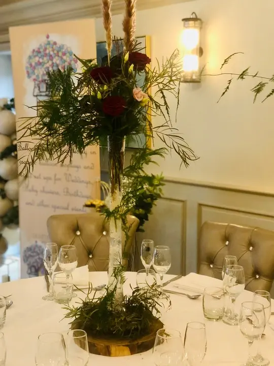 Tall Table Centrepiece with Red Roses and Wild Foliage