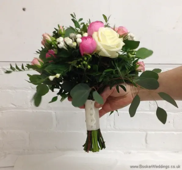 Semi-wild pale pink and cream Bridesmaid Bouquet with roses, ranunculus, bouvardia, spray roses and eucalyptus side view