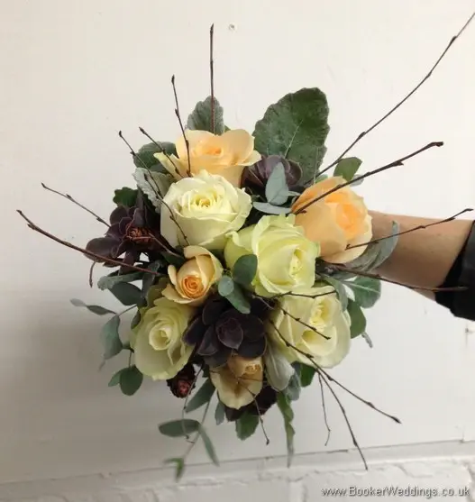 Winter woodland themed wedding Bridal bouquet with Cream avalanche & peach roses, burgundy succulents, copper cones & twigs