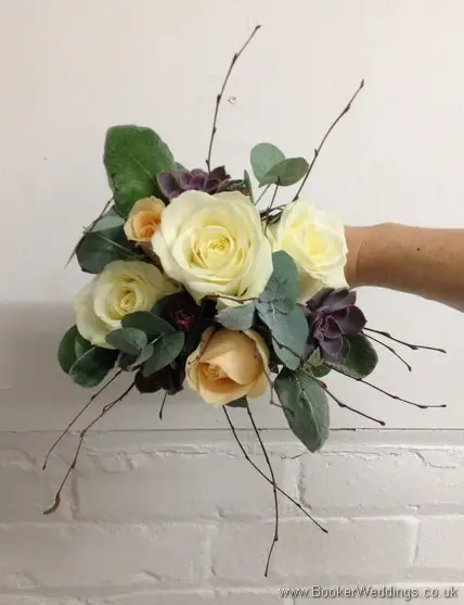 Winter woodland themed wedding Bridesmaid bouquet with Cream avalanche & peach roses, burgundy succulents, copper cones & twigs