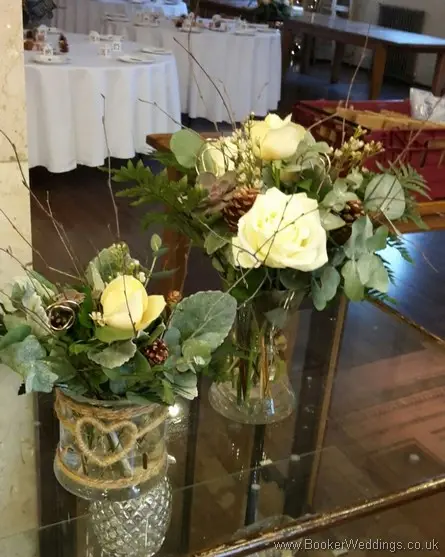 Winter woodland themed wedding Cake table decorations with Cream avalanche & peach roses, burgundy succulents, copper cones & twigs