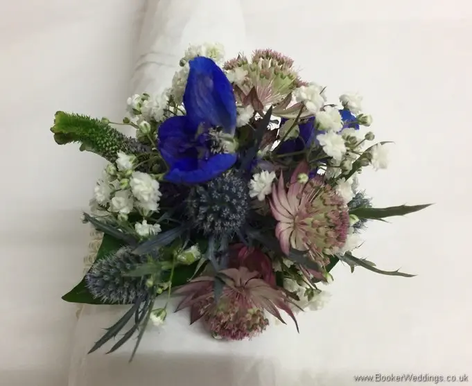 Blue and purple wild and rustic wrist corsage with eryngium, astrantia, veronica and gypsophila