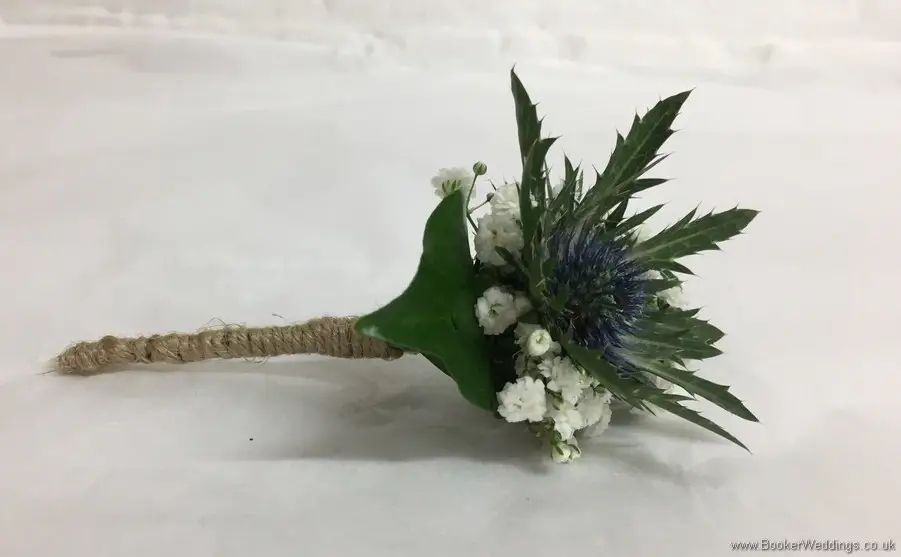 Rustic country style buttonhole with eryngium and gypsy grass