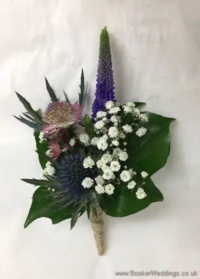 Rustic wild just picked blue and purple grooms buttonhole with eryngium, astrantia, veronica and gypsophila tied with twine