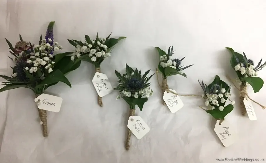 Wild rustic wedding party buttonholes tied with string and name tags