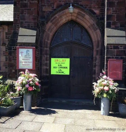 2 large just picked country style milk churn arrangements for entrance to St Barnabus Church, Liverpool