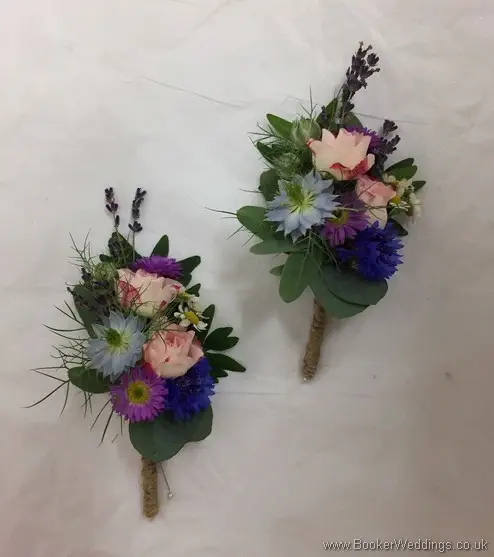 2 x pin corsages in a wild rustic just picked country style. Bright pinks, blues and purples wedding flower theme front view