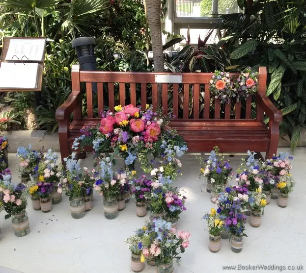 Top Table Arrangement, Table Centrepieces and Bride and Grooms Chair Decorations waiting at The Palm House, Sefton