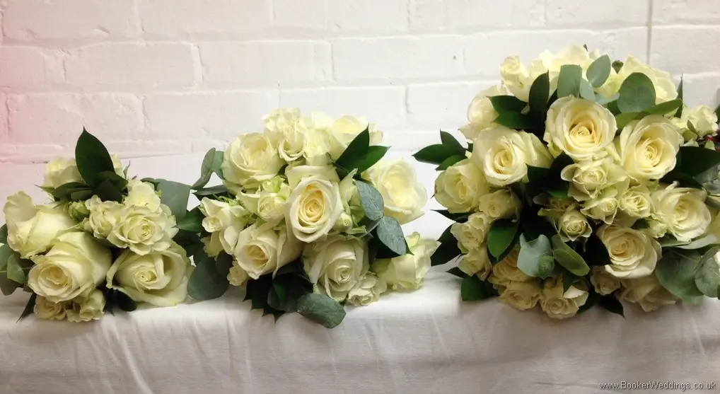 All white rose bride, bridesmaid and flowergirl bouquets