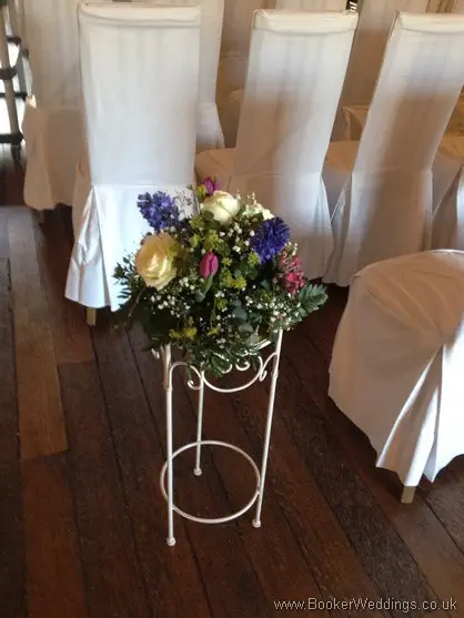 Small Pedestal Aisle Arrangements with Ivory rose, purple tulips, blue hyacinth, gypsy grass, pink bouvardia at Knowsley Hall