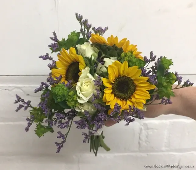 Mini Flowergirl handtied bouquet with yellow gerberas, white spray roses, purple limoneum and purple lissianthus tilted view