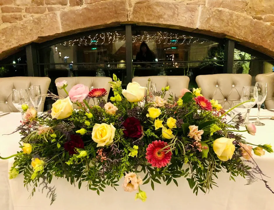Bright Spring Top Table Arrangement at Allerton Manor Wedding Fair