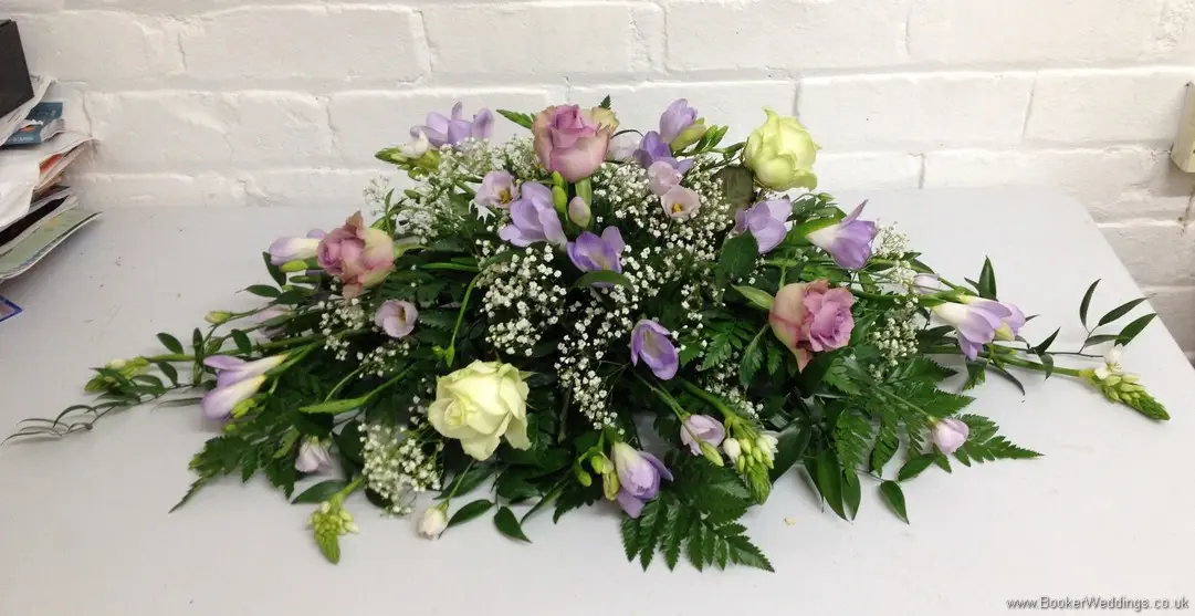Lilac and Ivory Roses, Lilac Freesia, Gypsy Grass, Lilac Lissianthus with diamantes in roses Top Table Arrangement for The Racquet Club