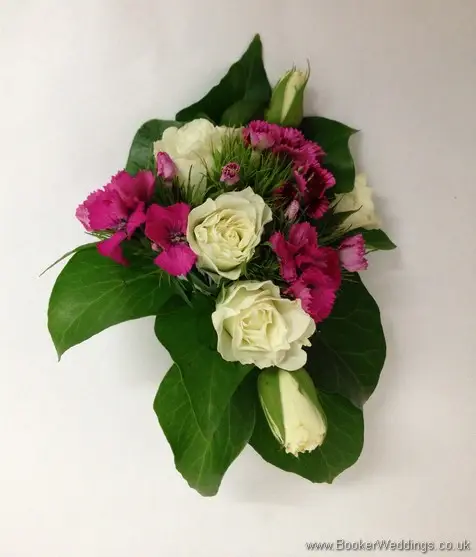 Wedding pin corsage featuring white spray roses and cerise sweet william