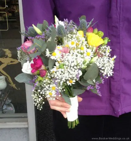 Multicoloured bridesmaid bouquet with eryngium, daisy, spray rose, lisianthus and freesias