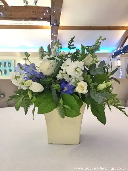 Table Centrepieces in Pots of Wild Style Wedding Flowers including Delphinium Stocks Lissianthus Spray Roses