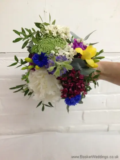 Flowergirl bouquet in a country wild flower style with Peony, Queens Anne Lace, Lavender ,Freesia, Sweet William, Scillia blue Bells, Red Santini Daisy